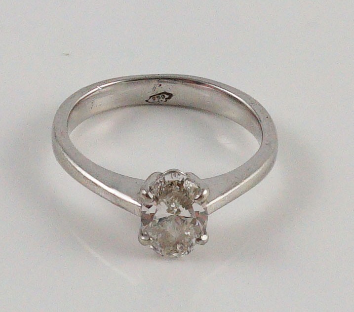 A modern platinum and solitaire oval cut diamond set ring
